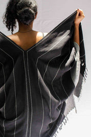 A model wearing the Anna Cape in colour Blue (Blue), from the back