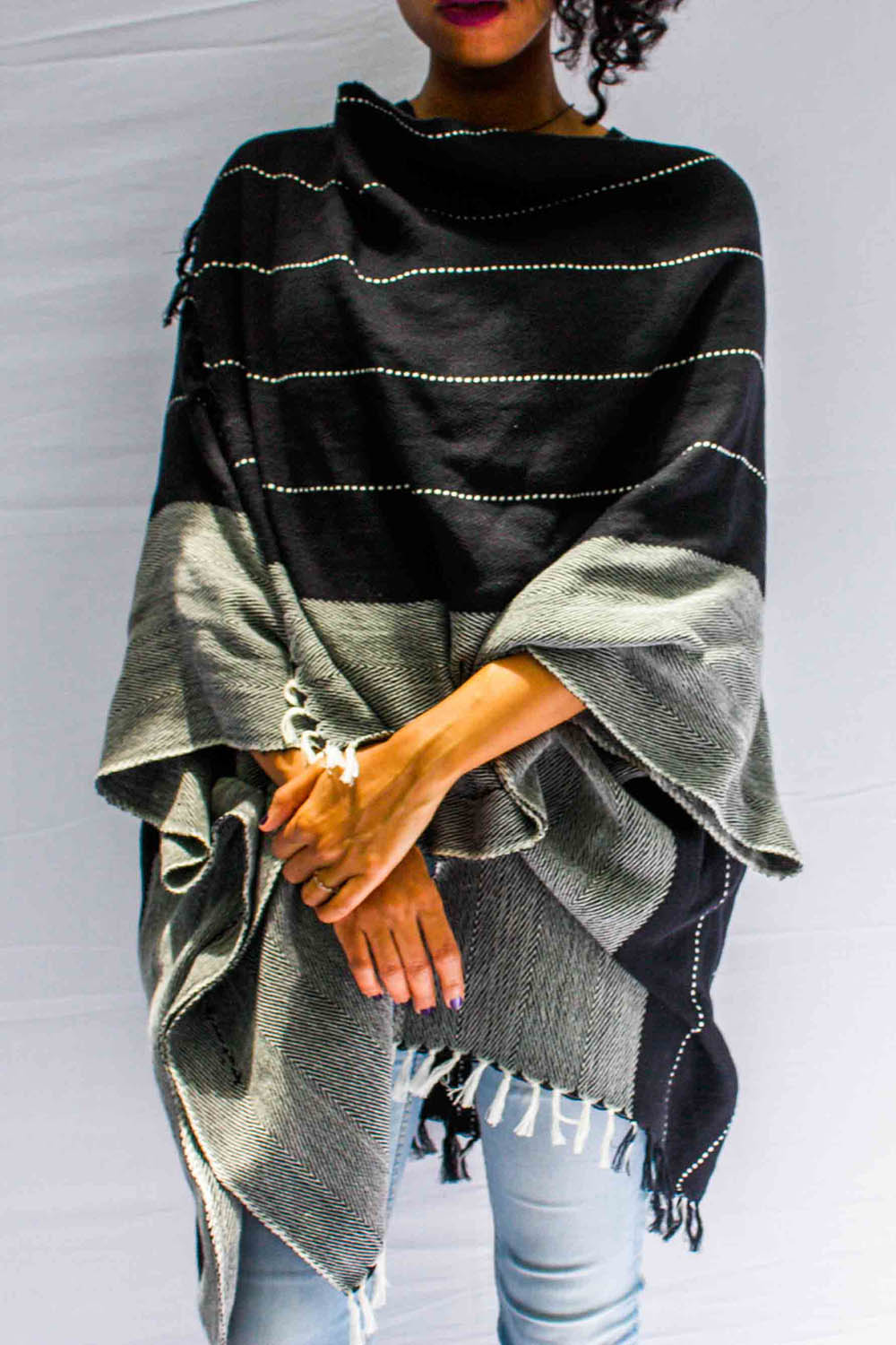 A model wearing the Anna Cape in colour Blue (Blue), from the front, cropped image