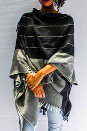 A model wearing the Anna Cape in colour Blue (Blue), from the front, cropped image