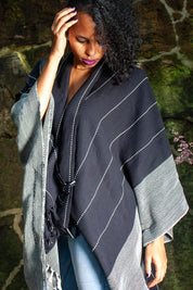 A model wearing the Anna Cape in colour Blue (Blue), from the front, showing the whole outfit