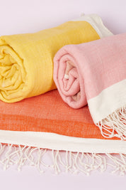 A model wearing size OneSize of the Handwoven Abay Beach Towel in colour Blush (Pink), from the front, showing the whole outfit