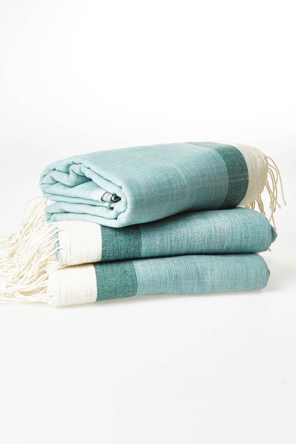 A model wearing size OneSize of the Handwoven Abay Beach Towel in colour GreenTeal (Green), from the front, showing the whole outfit