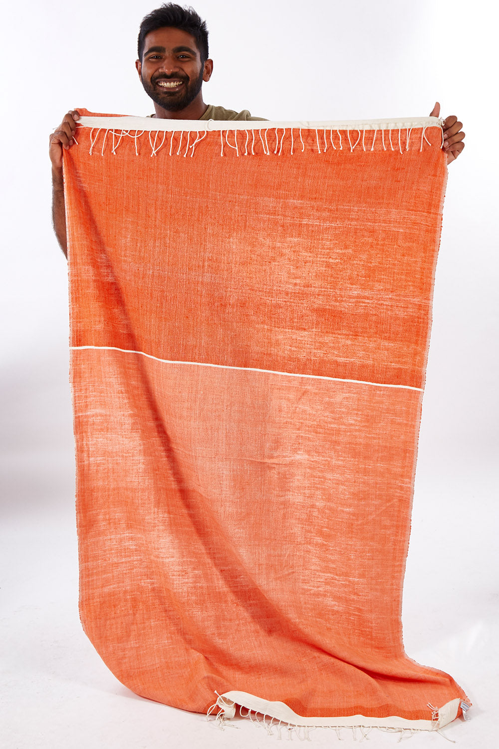 A model wearing size OneSize of the Handwoven Abay Beach Towel in colour Tangerine, from the front, showing the whole outfit