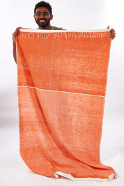 A model wearing size OneSize of the Handwoven Abay Beach Towel in colour Tangerine, from the front, showing the whole outfit