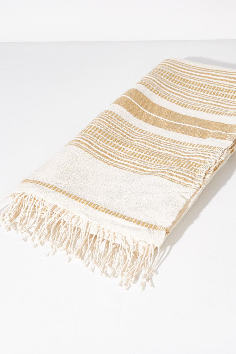 A model wearing size OneSize of the Handwoven Genale Bath Towel in colour Naturalbut, from the front, showing the whole outfit