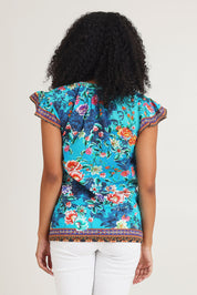 Model Ziara wearing size S of the Lotus Garden Sarah Cotton Top in colour Lotus (Blue), from the back