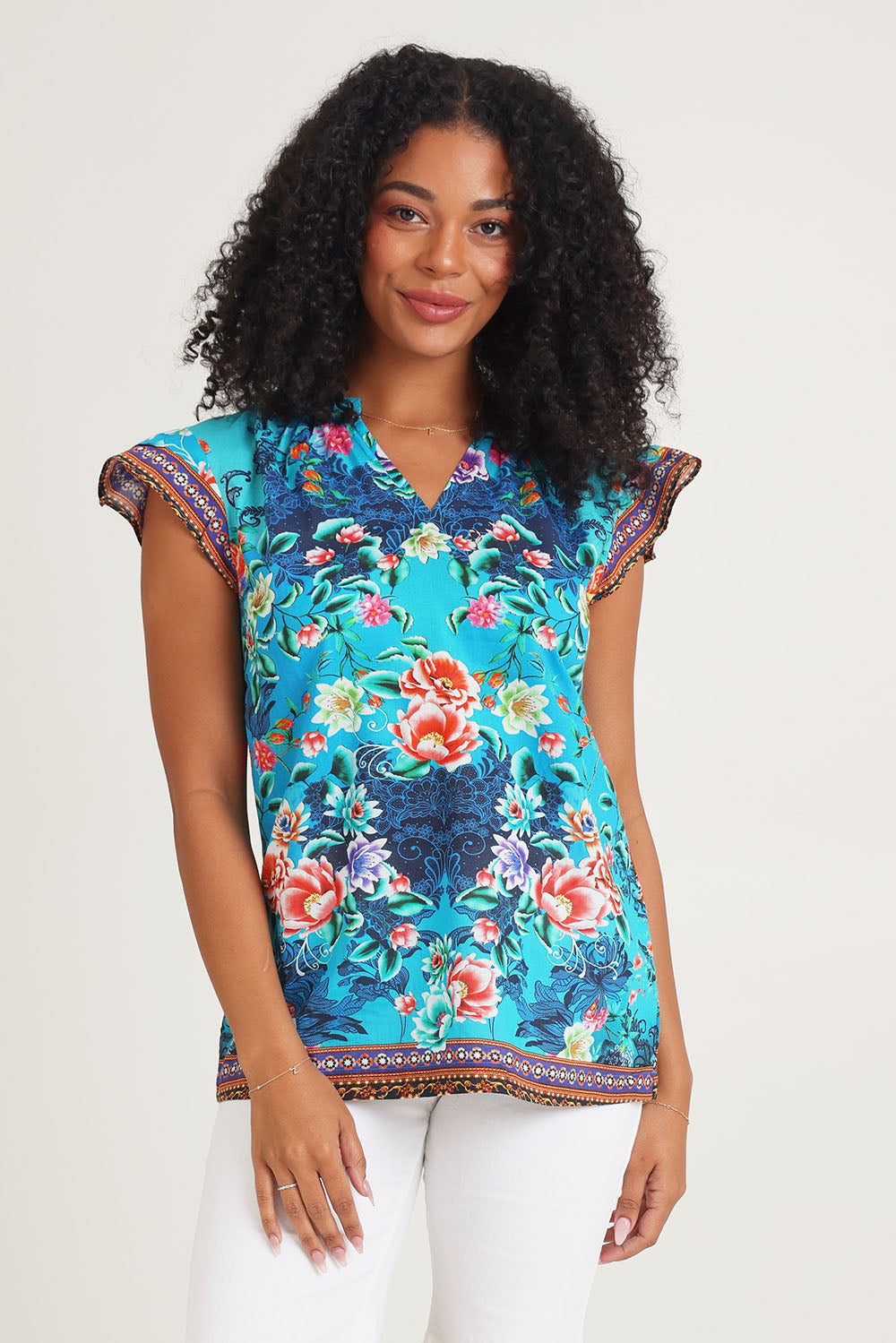 Model Ziara wearing size S of the Lotus Garden Sarah Cotton Top in colour Lotus (Blue), from the front, cropped image