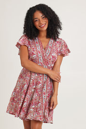 Model Ziara wearing size S of the Cleo Silk Blend Wrap Dress in colour Cleo (Pink), from the front, cropped image