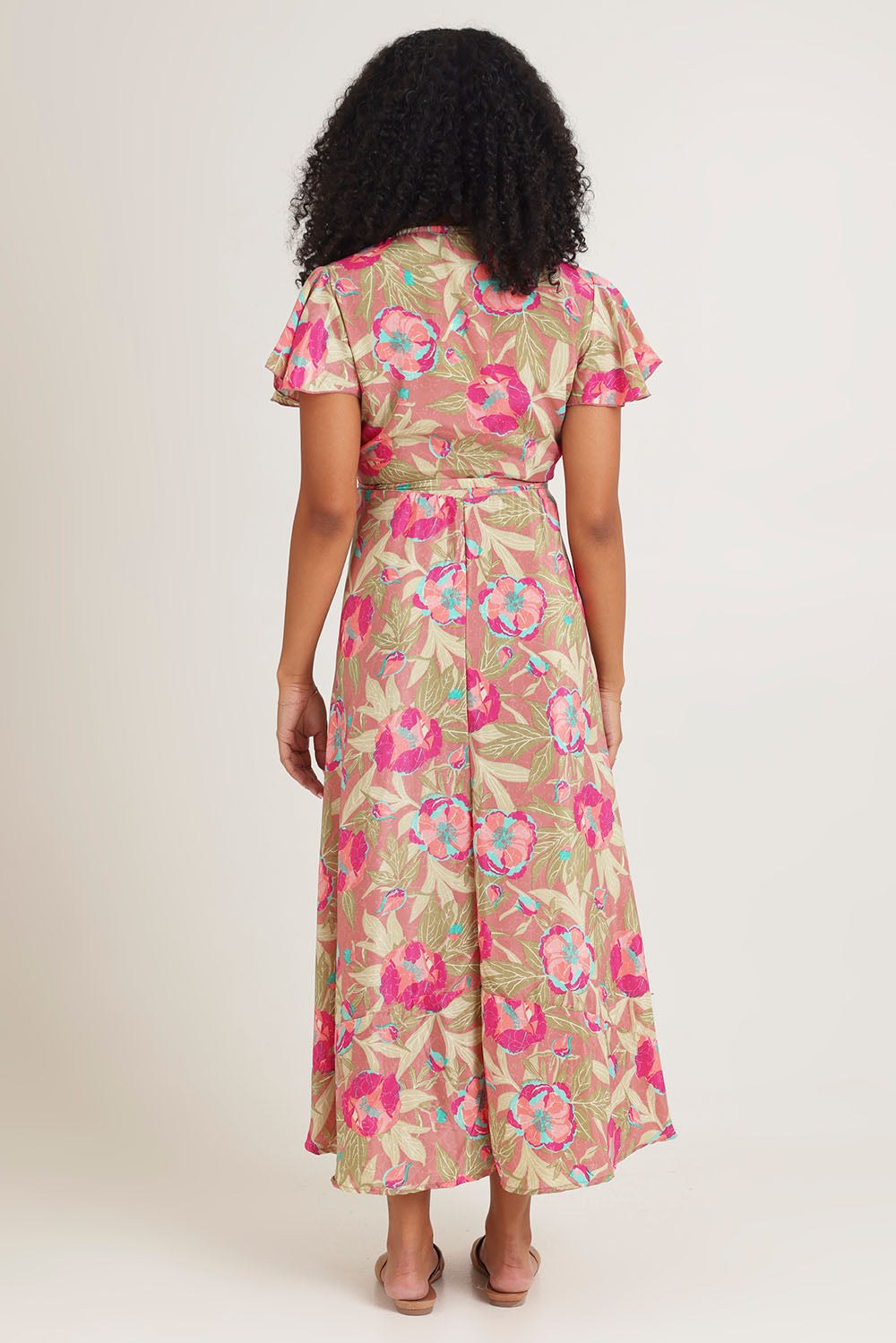 Model Ziara wearing size S of the Bloss Silk Blend Wrap Dress in colour Bloss (Pink), from the back