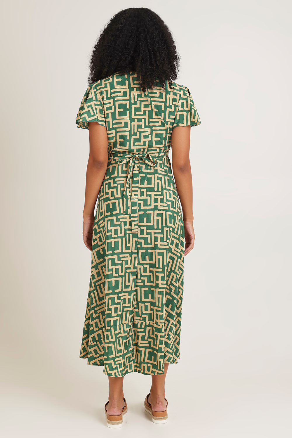 Model Ziara wearing size S of the Geo Silk Blend Wrap Dress in colour Green (Green), from the back