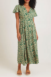 Model Ziara wearing size S of the Geo Silk Blend Wrap Dress in colour Green (Green), from the front, cropped image