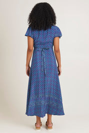 Model Ziara wearing size S of the Pirrin Silk Blend Wrap Dress in colour Pirrin (Blue), from the back