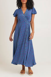 Model Ziara wearing size S of the Pirrin Silk Blend Wrap Dress in colour Pirrin (Blue), from the front, cropped image