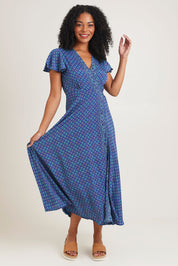 Model Ziara wearing size S of the Pirrin Silk Blend Wrap Dress in colour Pirrin (Blue), from the front, showing the whole outfit