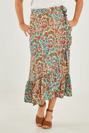 Model Georgia wearing size OneSize of the Eden Wrap Skirt in colour Eden (Blue), from the front, cropped image