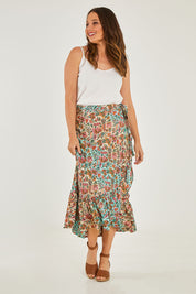 Model Georgia wearing size OneSize of the Eden Wrap Skirt in colour Eden (Blue), from the front, showing the whole outfit