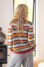 A model wearing the Aspen Sweater in colour Aspen, from the back