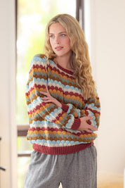 A model wearing the Aspen Sweater in colour Aspen, from the front, showing the whole outfit