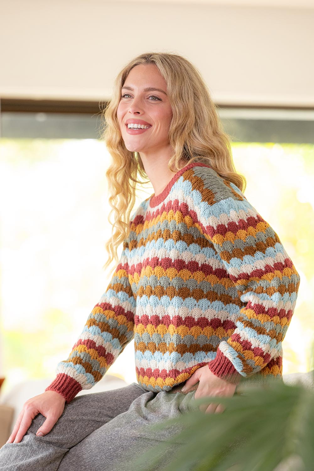 A model wearing the Aspen Sweater in colour Aspen, from the front, showing the whole outfit