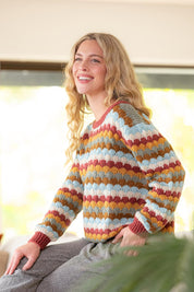 A model wearing the Aspen Sweater in colour Aspen, from the front, showing the whole outfit
