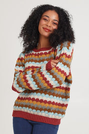 Model Ziara wearing the Aspen Sweater in colour Aspen, from the front, cropped image