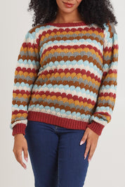 Model Ziara wearing the Aspen Sweater in colour Aspen, from the front, cropped image