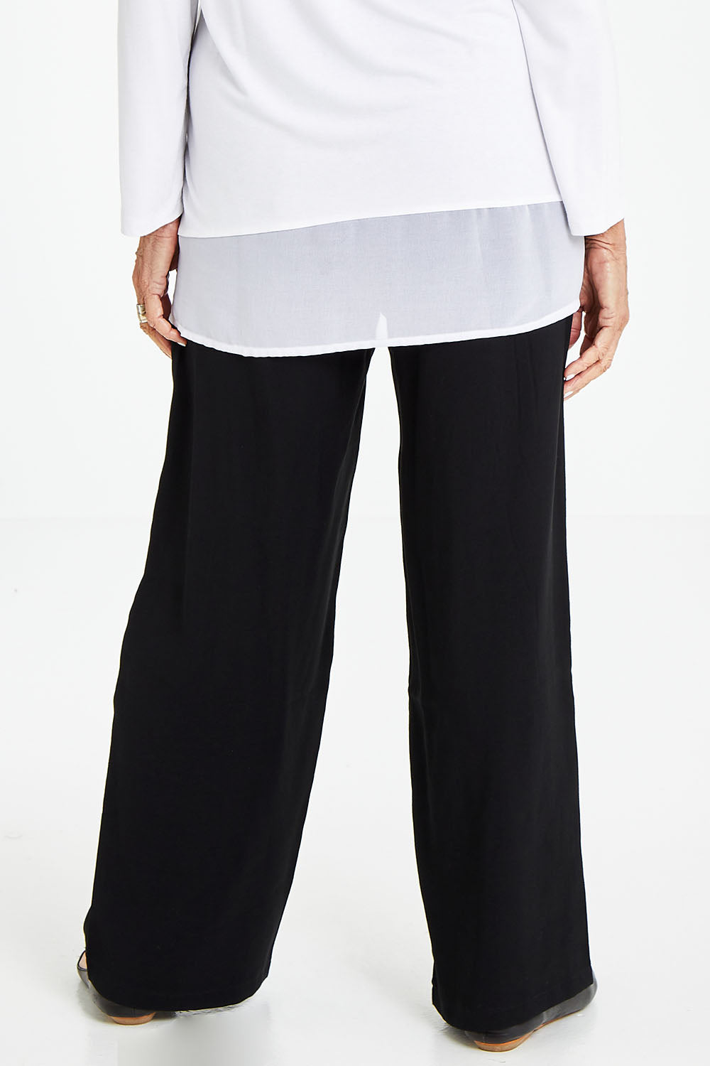 Model Elise wearing size S of the Wide Leg Relaxed Pant in colour Black (Black), from the back