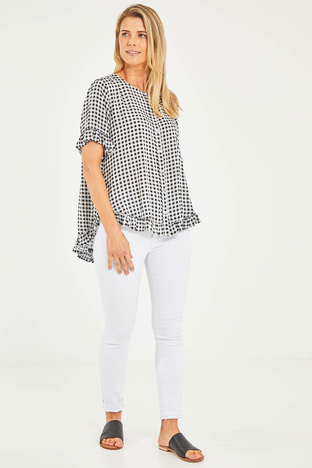 Model Kelly wearing size S of the Check Frill Hem Top in colour Black (Black), from the front, showing the whole outfit