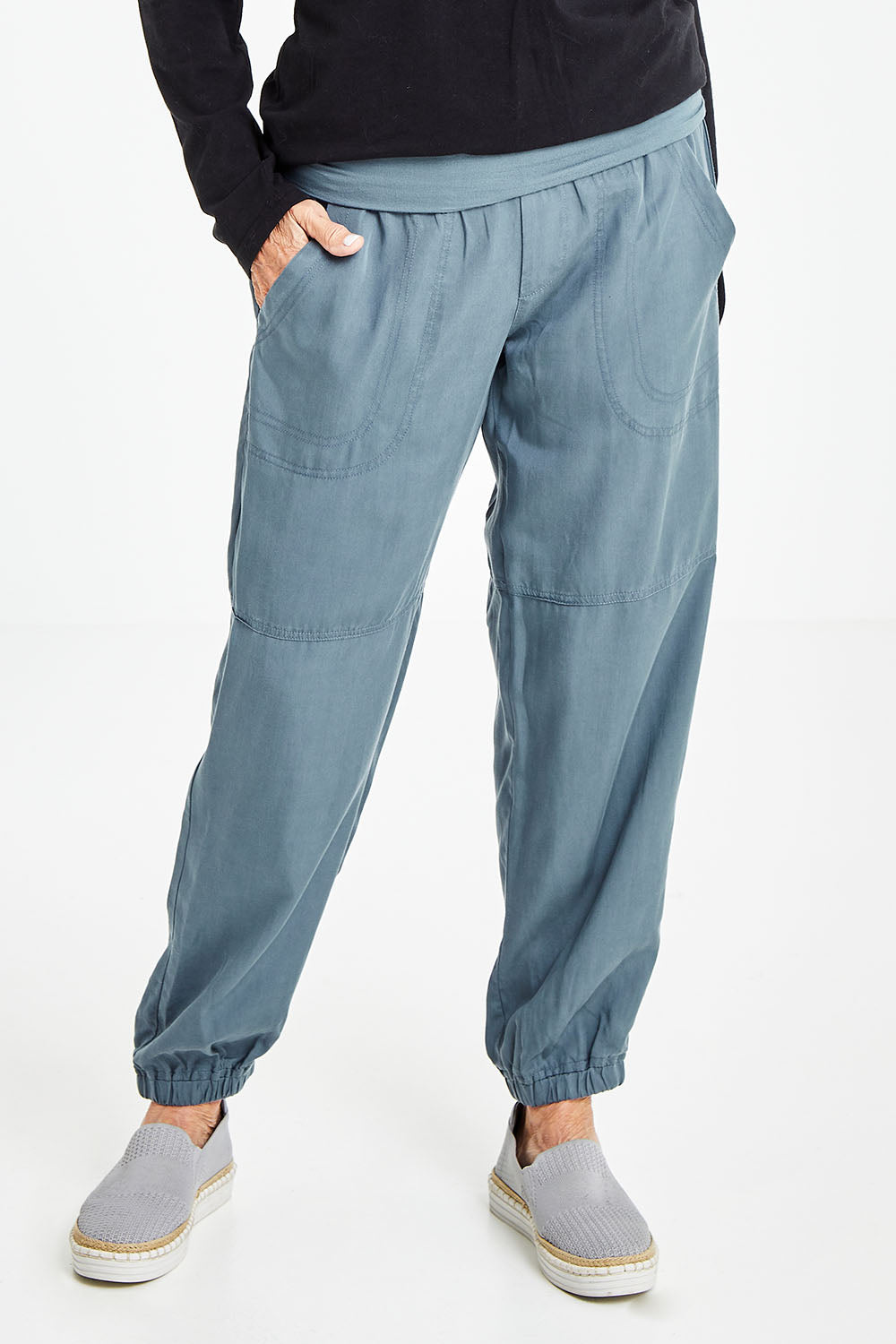 Model Elise wearing size S of the Lyocell Pant in colour Slate (Grey), from the front, cropped image
