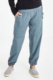 Model Elise wearing size S of the Lyocell Pant in colour Slate (Grey), from the front, cropped image
