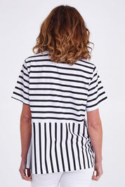 Model Emma wearing size S of the Visa Vera Cotton Tee in colour Blkwhite (Black), from the back