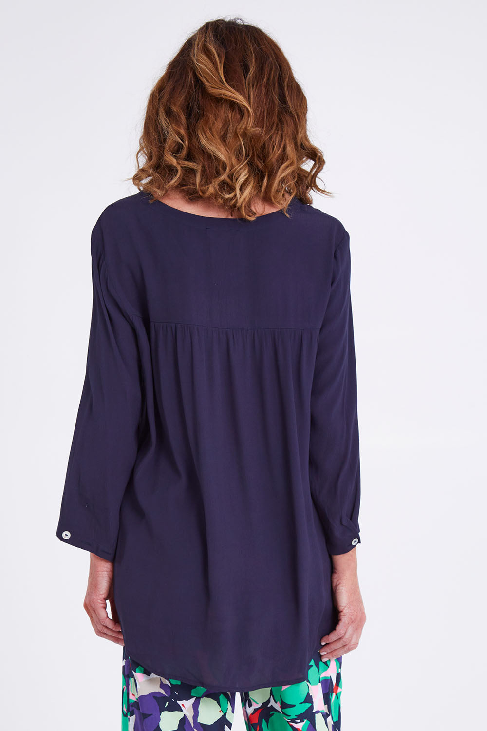 Model Emma wearing size S of the Madison Pocket Top in colour Navy (Blue), from the back