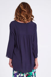 Model Emma wearing size S of the Madison Pocket Top in colour Navy (Blue), from the back