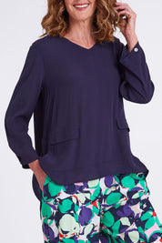 Model Emma wearing size S of the Madison Pocket Top in colour Navy (Blue), from the front, cropped image