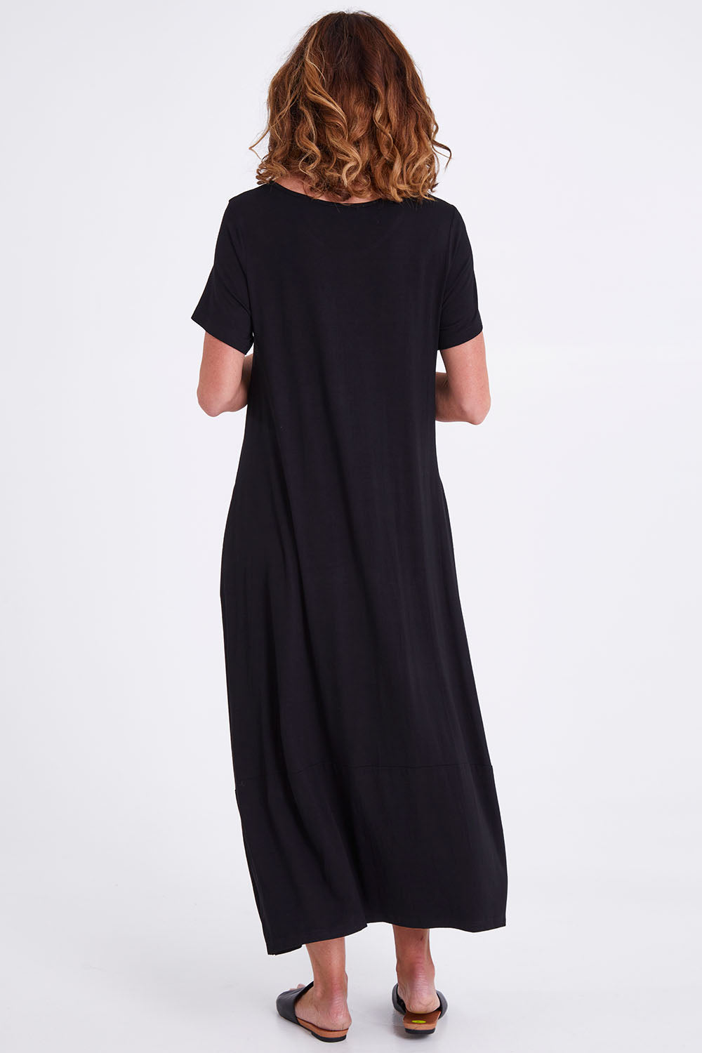 Model Emma wearing size S of the Adios Dress in colour Black (Black), from the back