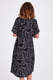 Model Emma wearing size S of the Empire Dress in colour Black (Black), from the back