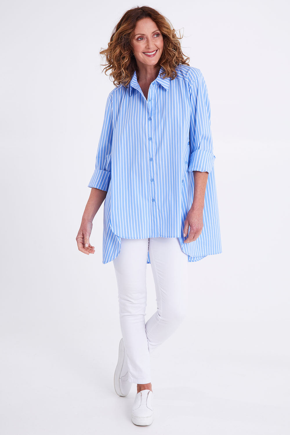 Model Emma wearing size S of the Banda Cotton Button Shirt in colour Bluewhite (Blue), from the front, showing the whole outfit
