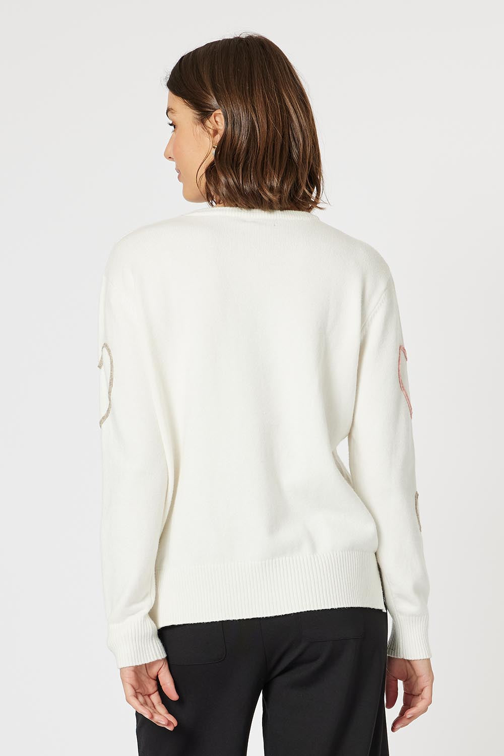 A model wearing the Love Me Knit Jumper in colour Ivory, from the back
