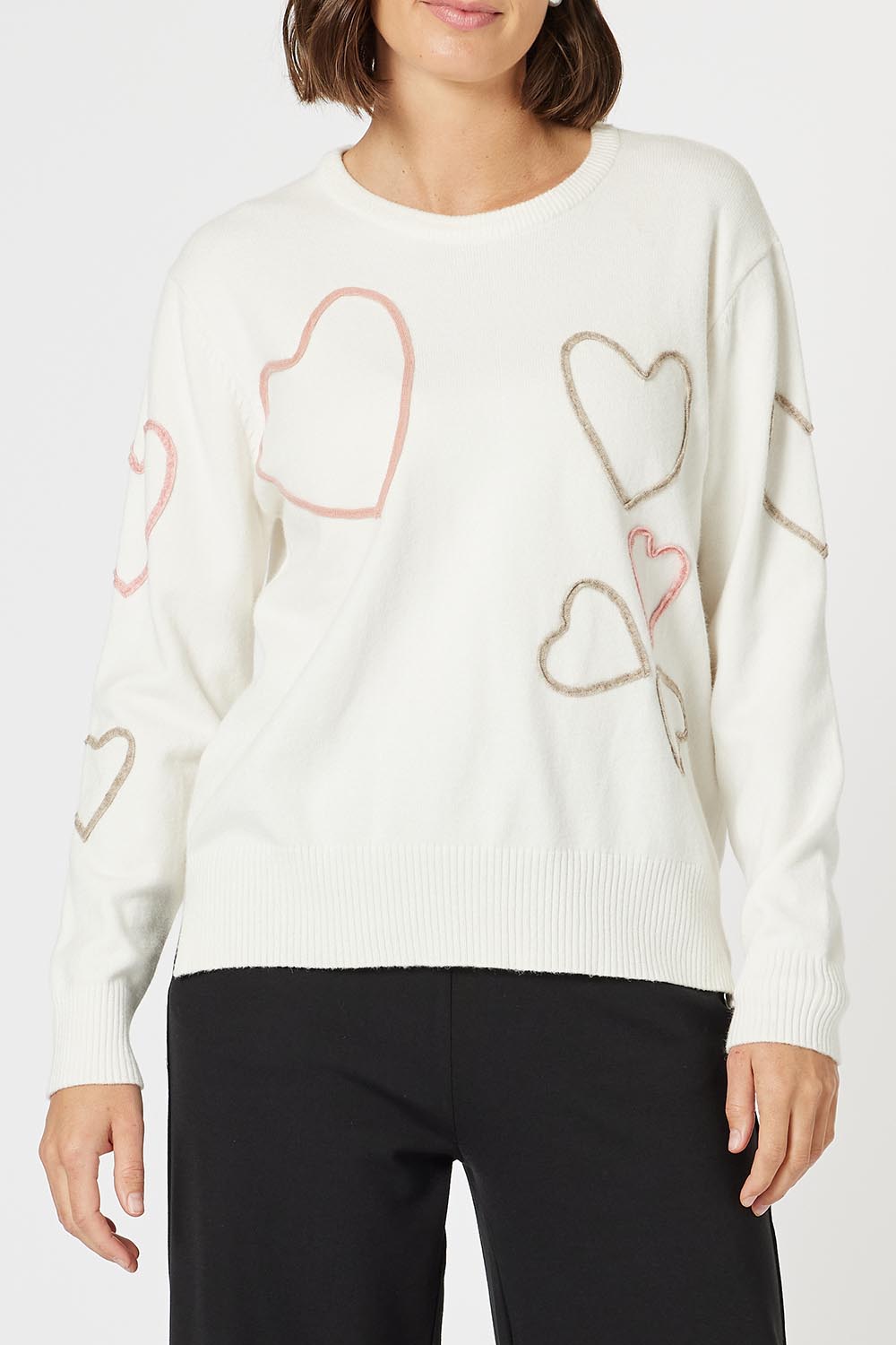 A model wearing the Love Me Knit Jumper in colour Ivory, from the front, cropped image