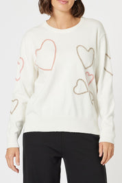 A model wearing the Love Me Knit Jumper in colour Ivory, from the front, cropped image