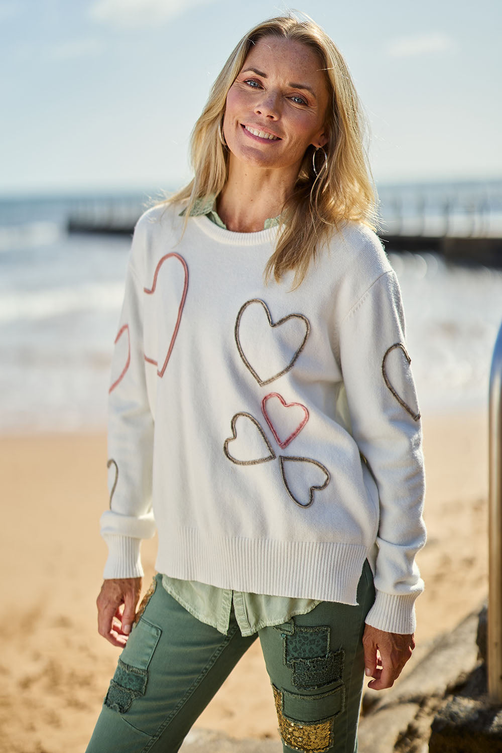 Model Maggie wearing size S of the Love Me Knit Jumper in colour Ivory, from the front, showing the whole outfit