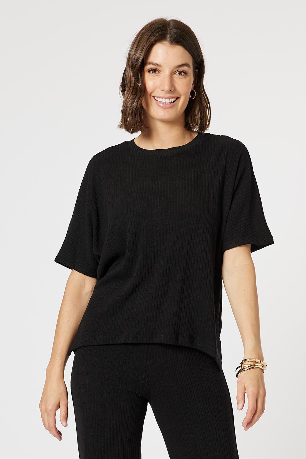 A model wearing the Lounge Top in colour Black (Black), from the front, cropped image