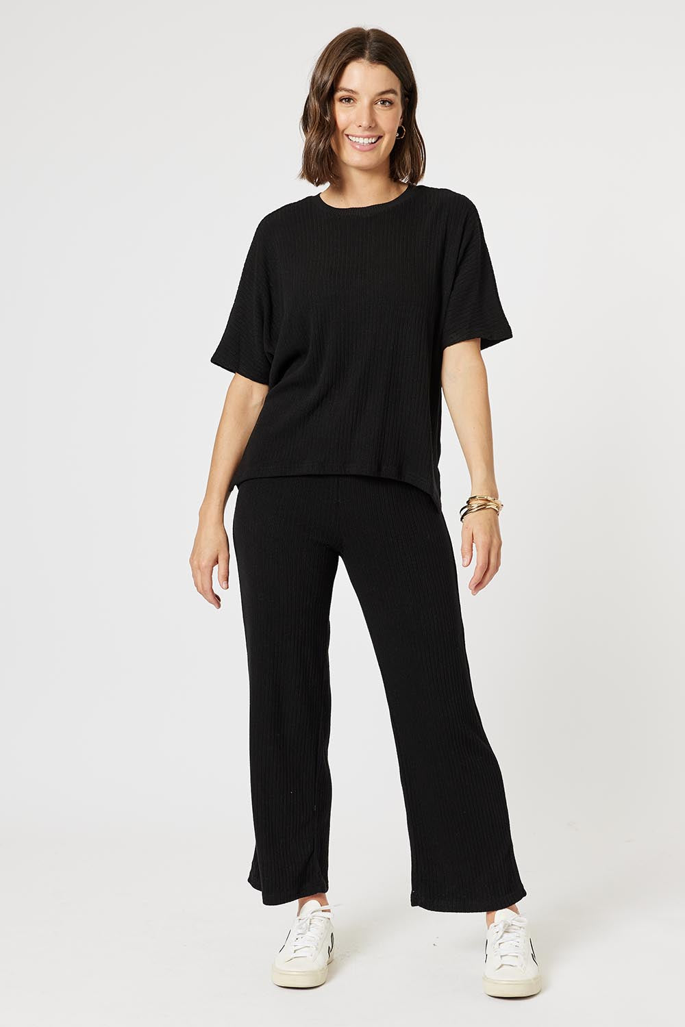 A model wearing the Lounge Top in colour Black (Black), from the front, showing the whole outfit