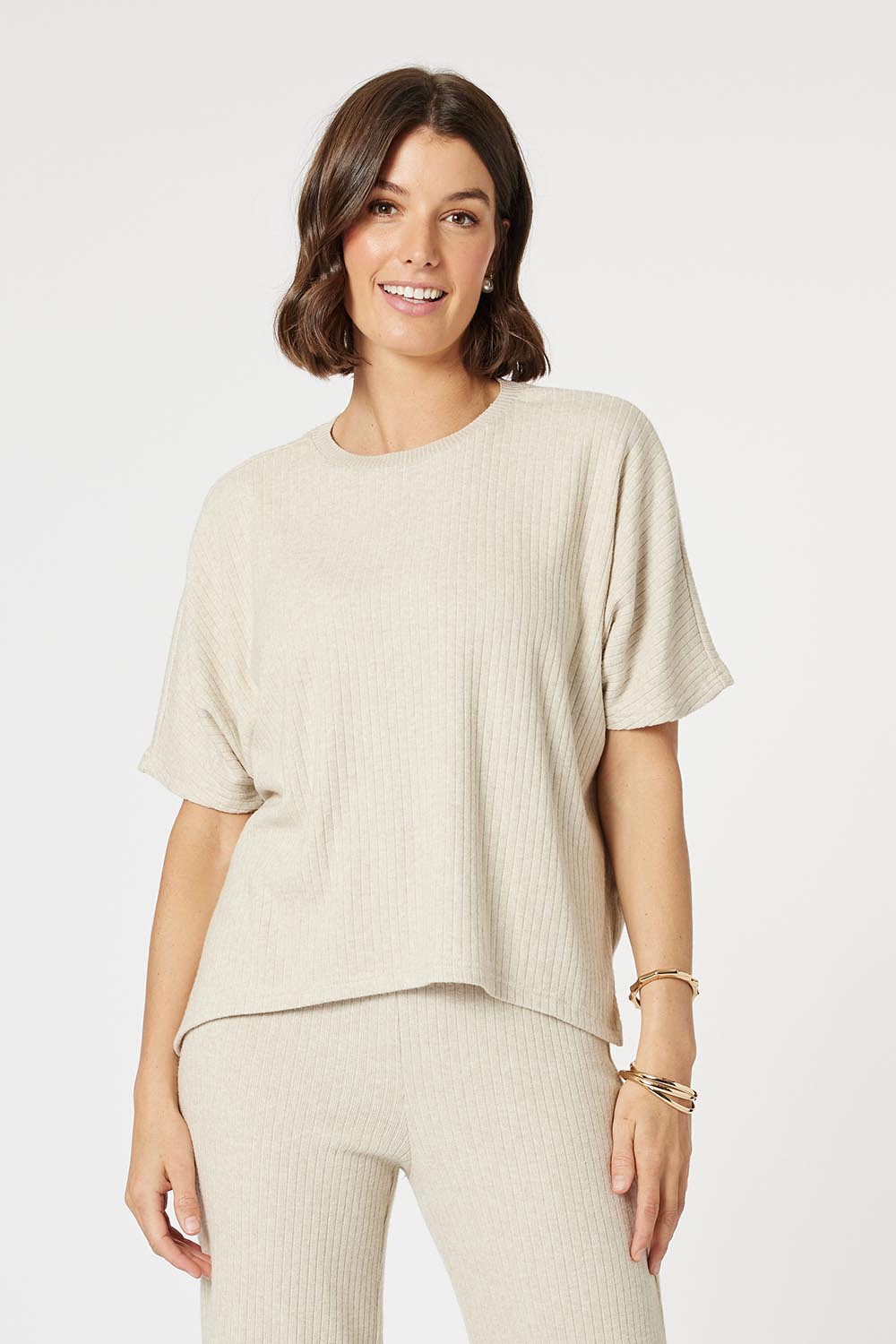 A model wearing the Lounge Top in colour Natural, from the front, cropped image