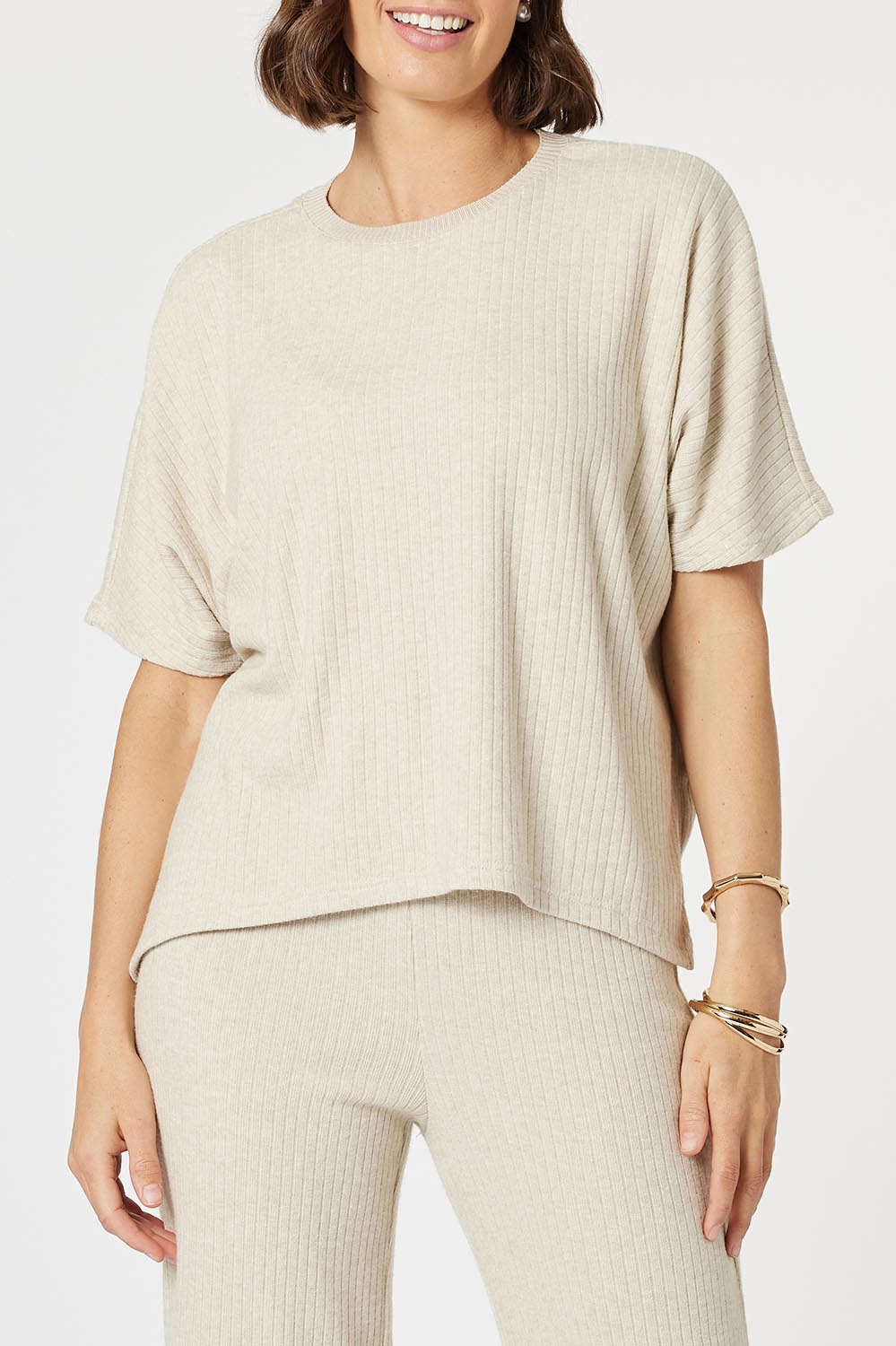 A model wearing the Lounge Top in colour Natural, from the front, cropped image