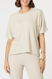 A model wearing the Lounge Top in colour Natural, from the front, cropped image
