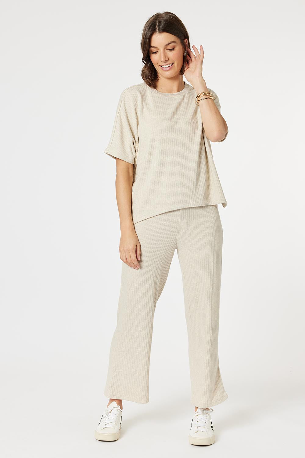 A model wearing the Lounge Top in colour Natural, from the front, showing the whole outfit