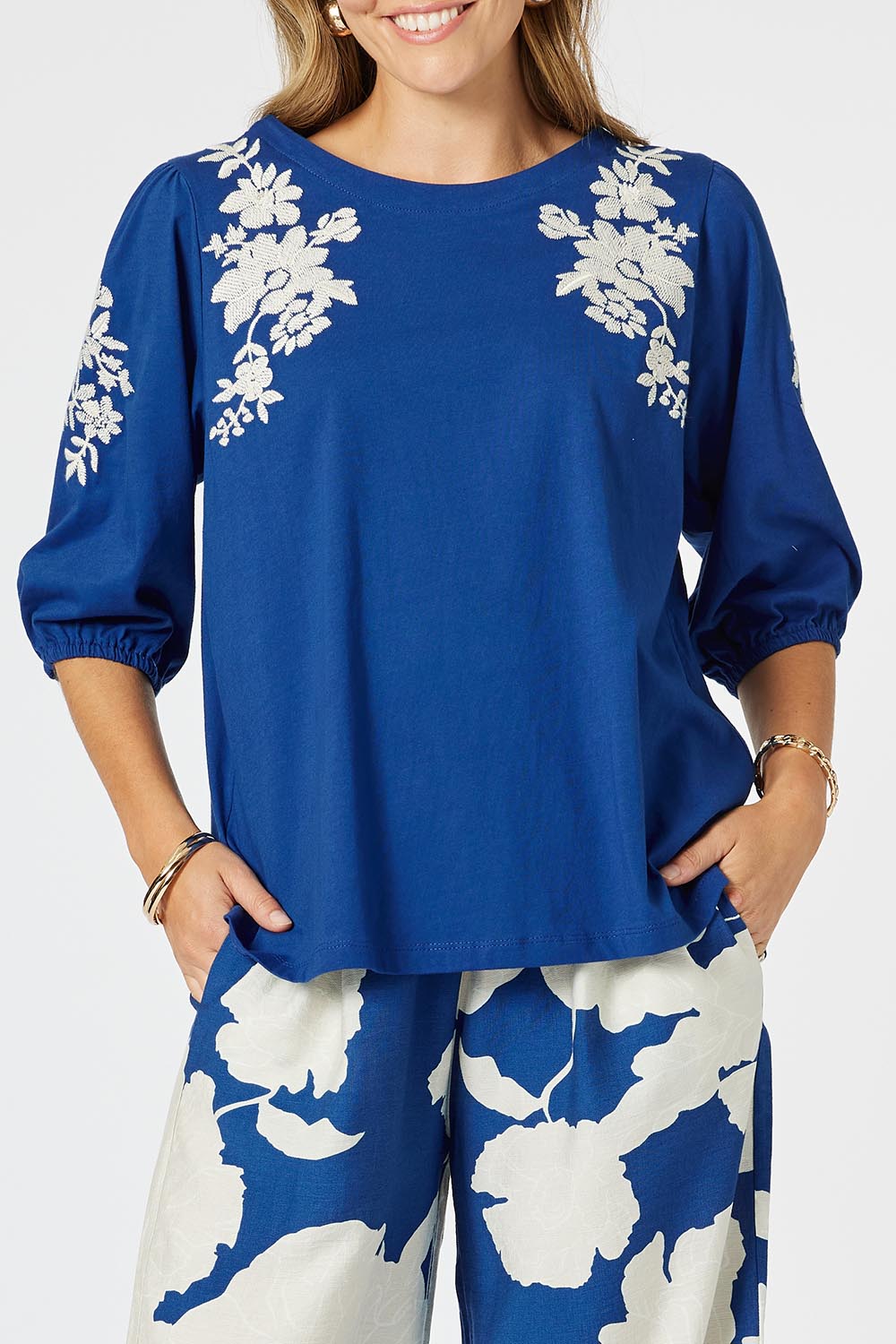 A model wearing the Jill Embroidered Cotton Tee in colour Blue (Blue), from the front, cropped image