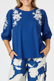 A model wearing the Jill Embroidered Cotton Tee in colour Blue (Blue), from the front, cropped image