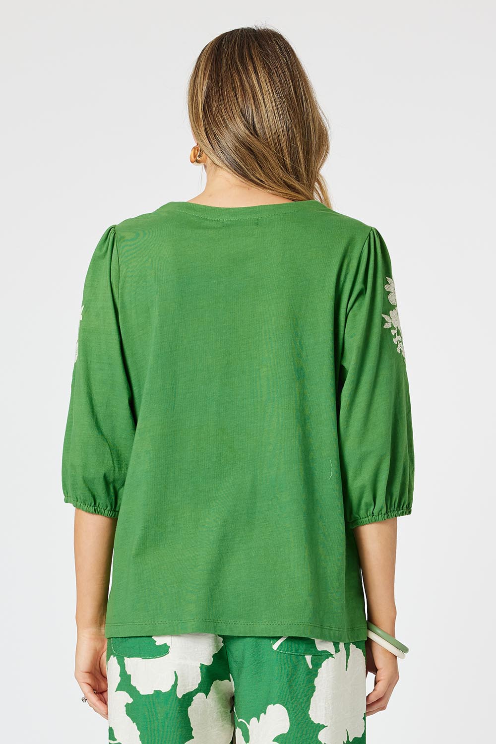 A model wearing the Jill Embroidered Cotton Tee in colour Elm (Green), from the back
